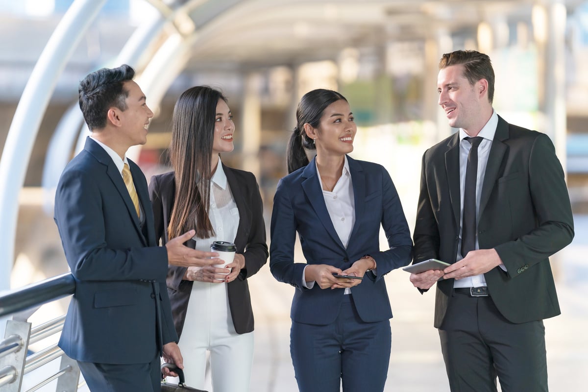 Business People Standing and Talk to Each Other in Front of Mode